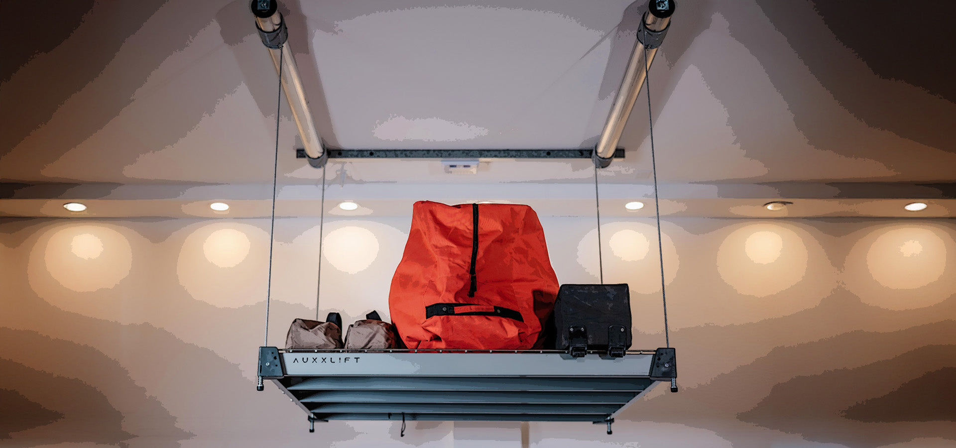 Retractable Motorized Platform Lift With Orange Bag Raised Up Toward Ceiling