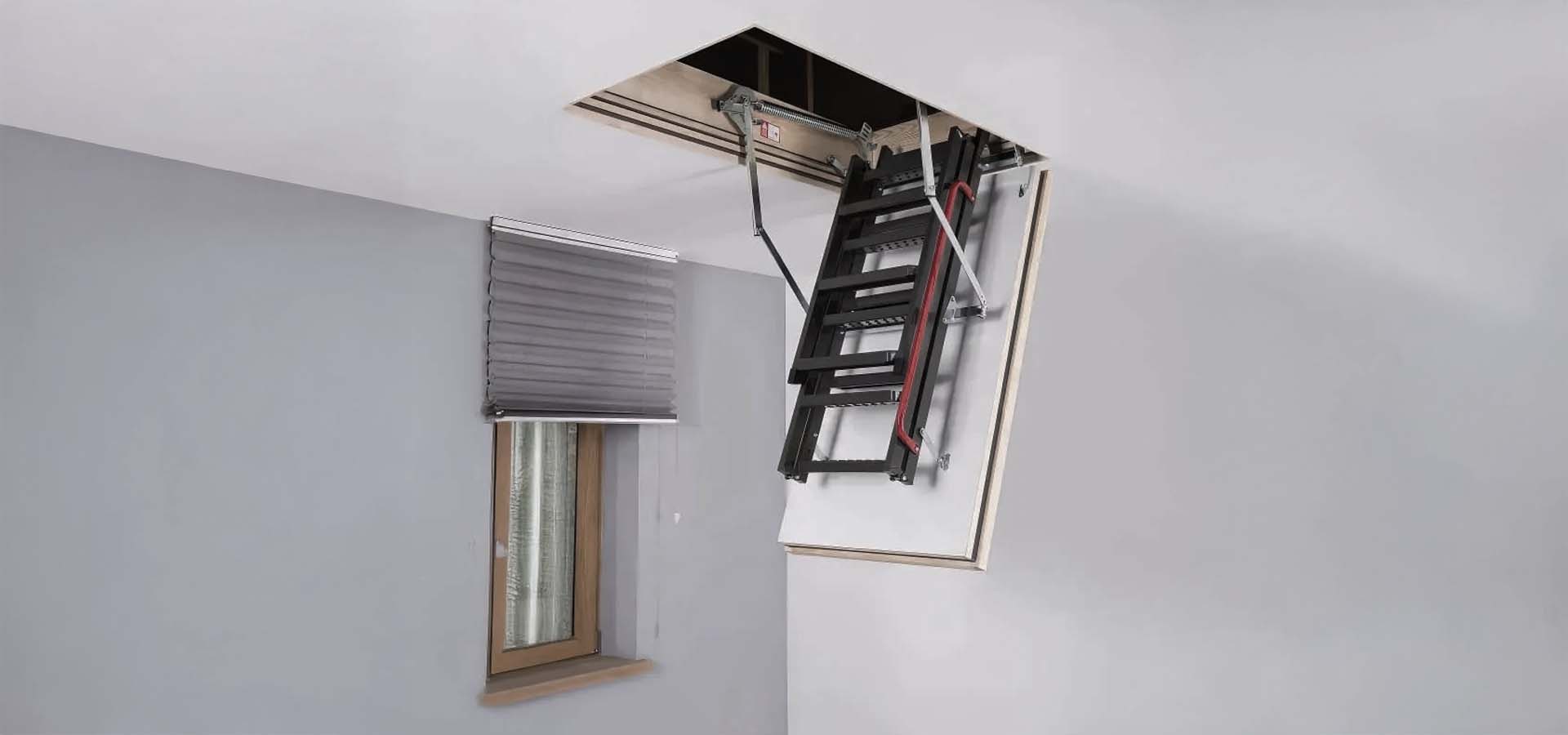 Foldable Attic Ladder Partially Extended From A Ceiling Opening
