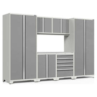 7 Piece Pro 3.0 Series Garage Cabinet Set Consisting Of Tall Cabinets, Overhead Cabinets, A Central Workbench, And A Drawer Unit