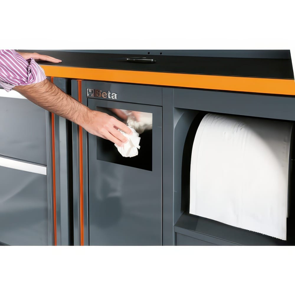A Person Wipes The Clear Door Window Of A Gray Beta Workshop Cabinet With An Integrated Paper Towel Roll And Orange Worktop Trim