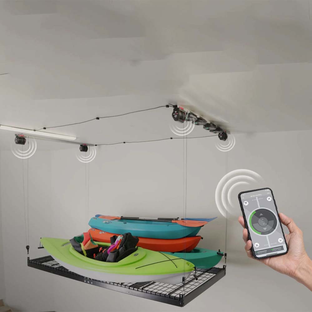 A Hand Holding A Smartphone Controlling Platform Storage Lift By Smarter Home Filled With Kayaks In A Garage Using A Digital App Interface