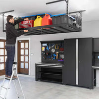 A Man Utilizing A Ladder To Place Items On A VersaRac Pro Overhead Rack 4 Ft X 8 Ft Height Adjustable In Black