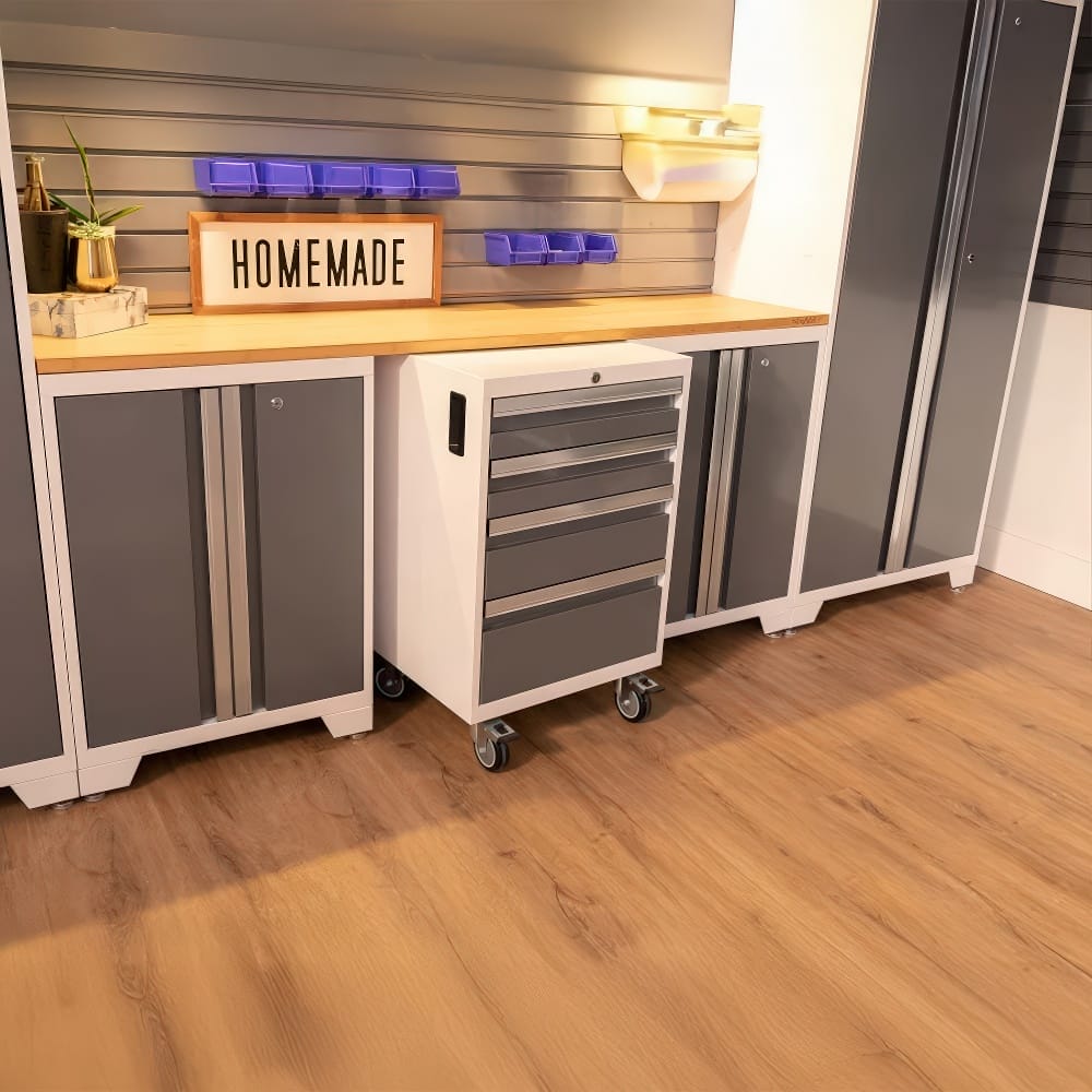 A Mobile Drawer Cabinet Sits Beneath A Butcher Block Countertop In A Sleek Garage Workspace