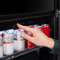 A Person Adjusts The Temperature Setting On A Beverage Cooler Stocked With Cans