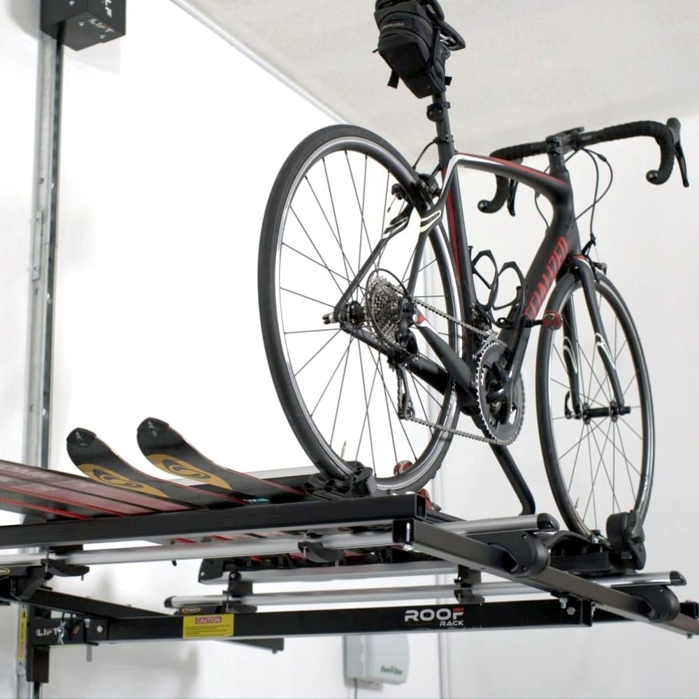 A Racing Bicycle And A Pair Of Skis Securely Mounted On An Adjustable Overhead Rack By Top Shelf Storage