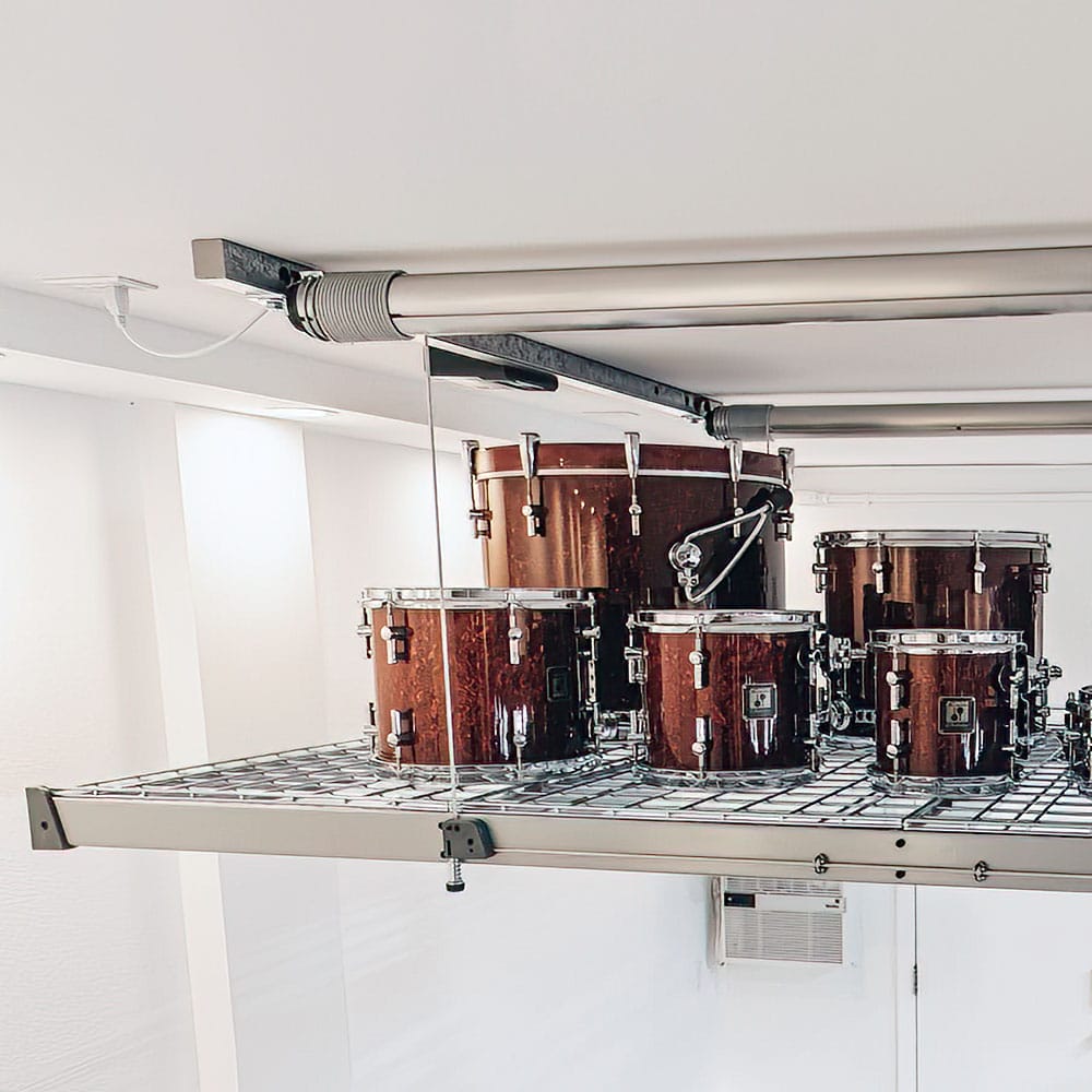 A Set Of Wooden Drums Elevated On A Metal Grid Storage Platform Of AuxxLift Garage Storage Lift System Motorized