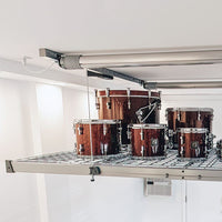 A Set Of Wooden Drums Elevated On A Metal Grid Storage Platform Of AuxxLift Garage Storage Lift System Motorized