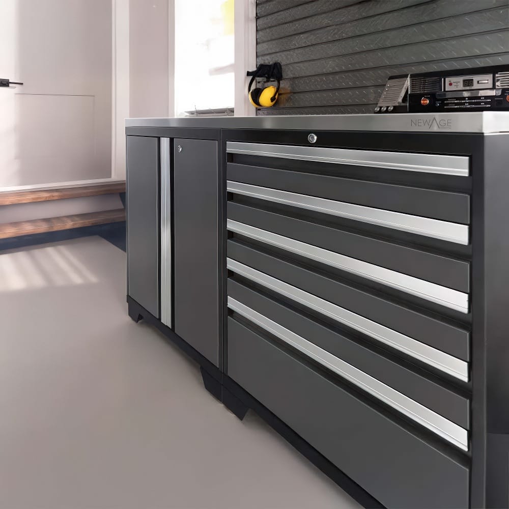 A Sleek Black And Silver Tool Chest With Multiple Drawers And A Side Cabinet Stands Against A Wall