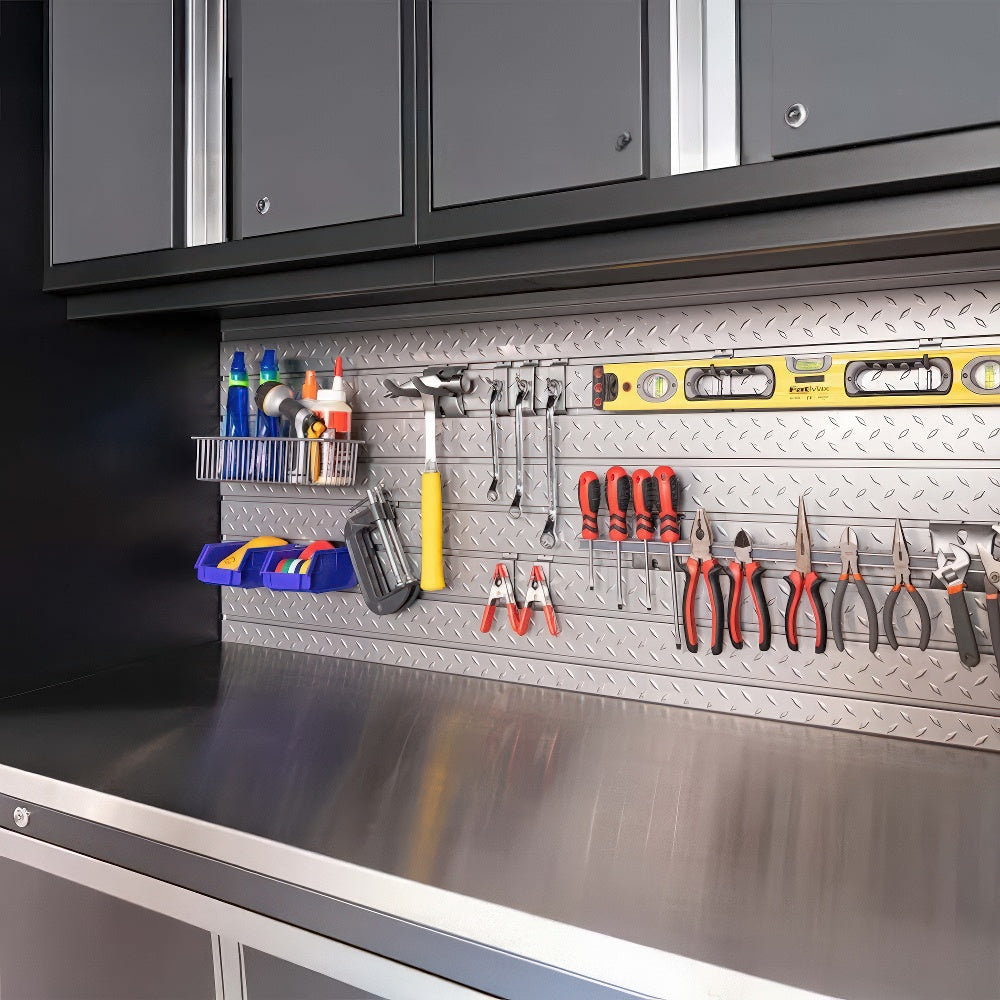 A Tidy Garage Workstation Features A Stainless Steel Countertop Overhead Cabinets And A Pegboard Wall