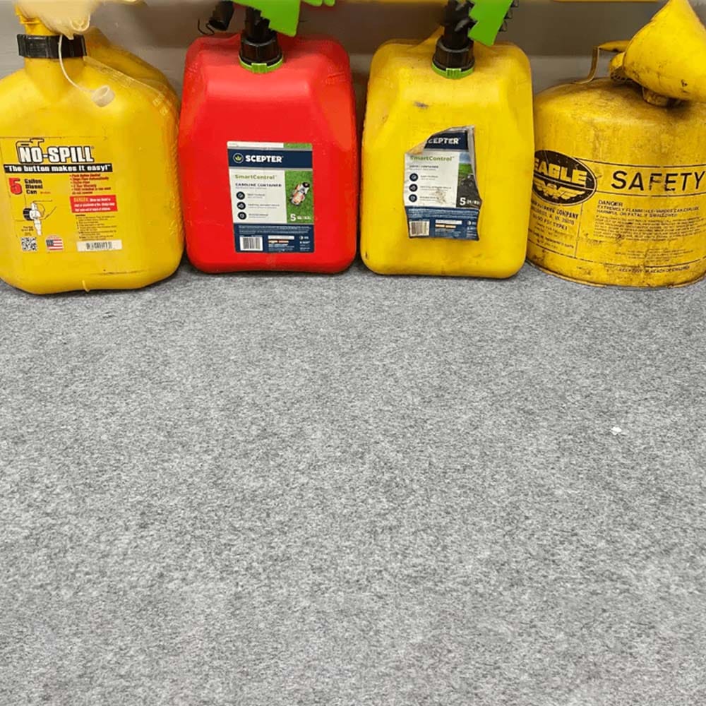Assortment Of Fuel Containers In Various Sizes And Colors Placed On A Gray Drip And Dry Floor