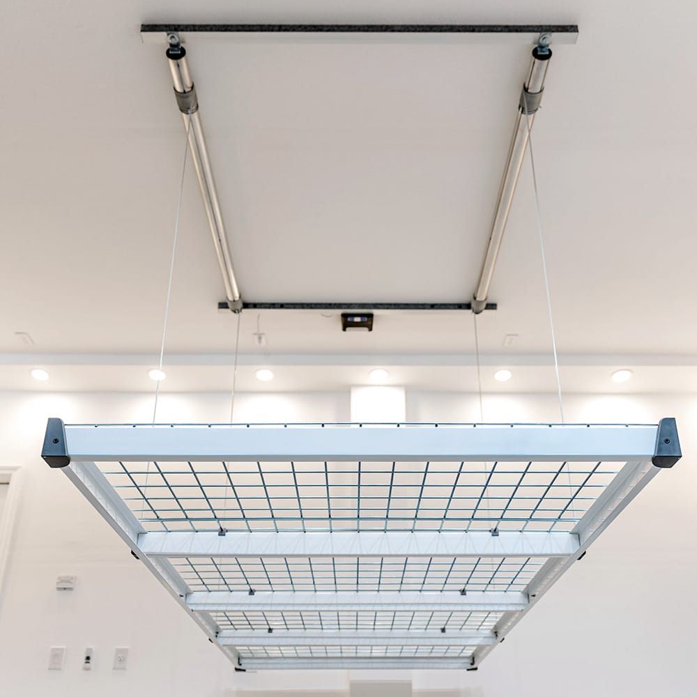 AuxxLift Garage Storage Lifts Suspended From The Ceiling Showcasing Its Grid Design And Pulley System