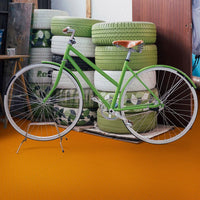 Bicycle With A Minimalist Design Standing In Front Of A Stack Of Recycled Tires, All Set Against Perfection Tile Rubber Garage Floor Tiles