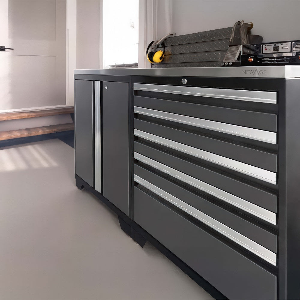 Black And Silver NewAge Cabinet System With Multiple Drawers And A Side Door Is Positioned Beneath A Window