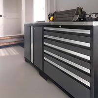 Black And Silver NewAge Cabinet System With Multiple Drawers And A Side Door Is Positioned Beneath A Window