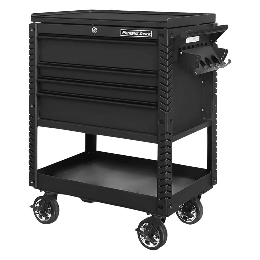 Black Extreme Tools Cart With Three Closed Drawers, A Handle On The Side, A Tool Holder Attachment, And A Lower Shelf All Mounted On Large Casters