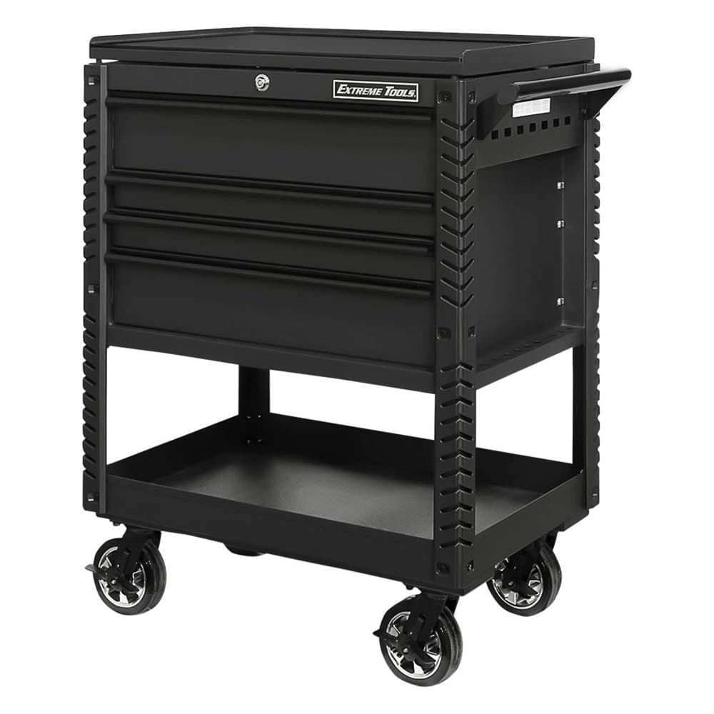 Black Rolling Tool Cart By Extreme Tools With Three Closed Drawers, A Handle On The Side, And A Lower Shelf All Supported By Large Casters