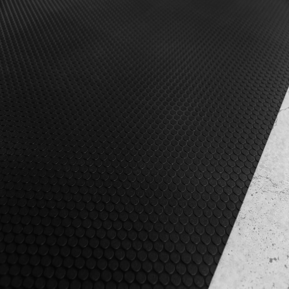 Black Small Coin Roll Out Flooring Featuring A Uniform Pattern Of Small Circular Indentations Across Its Surface