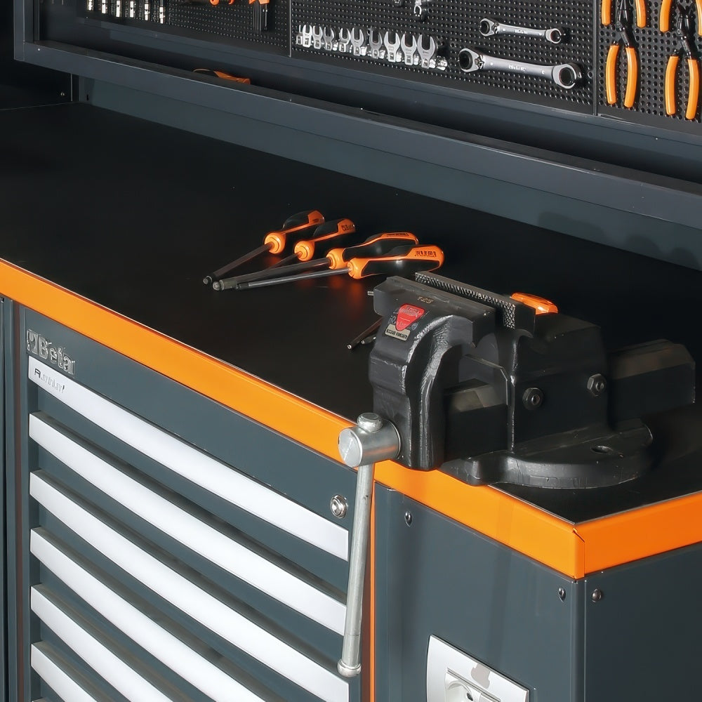 Black Workbench Surface With Orange Trim Bench Vise Loose Screwdrivers And Organized Hand Tools On The Overhead Pegboard