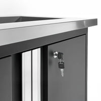 Cabinet With Keys Inserted In The Lock And A Sleek Stainless Steel Worktop