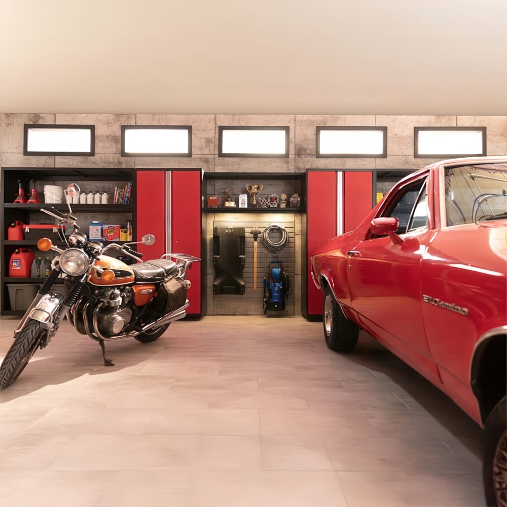 Cabinets Line The Garage Wall As A Vintage Motorcycle And Classic Red Car Flank A Centered Detailing And Tool Station