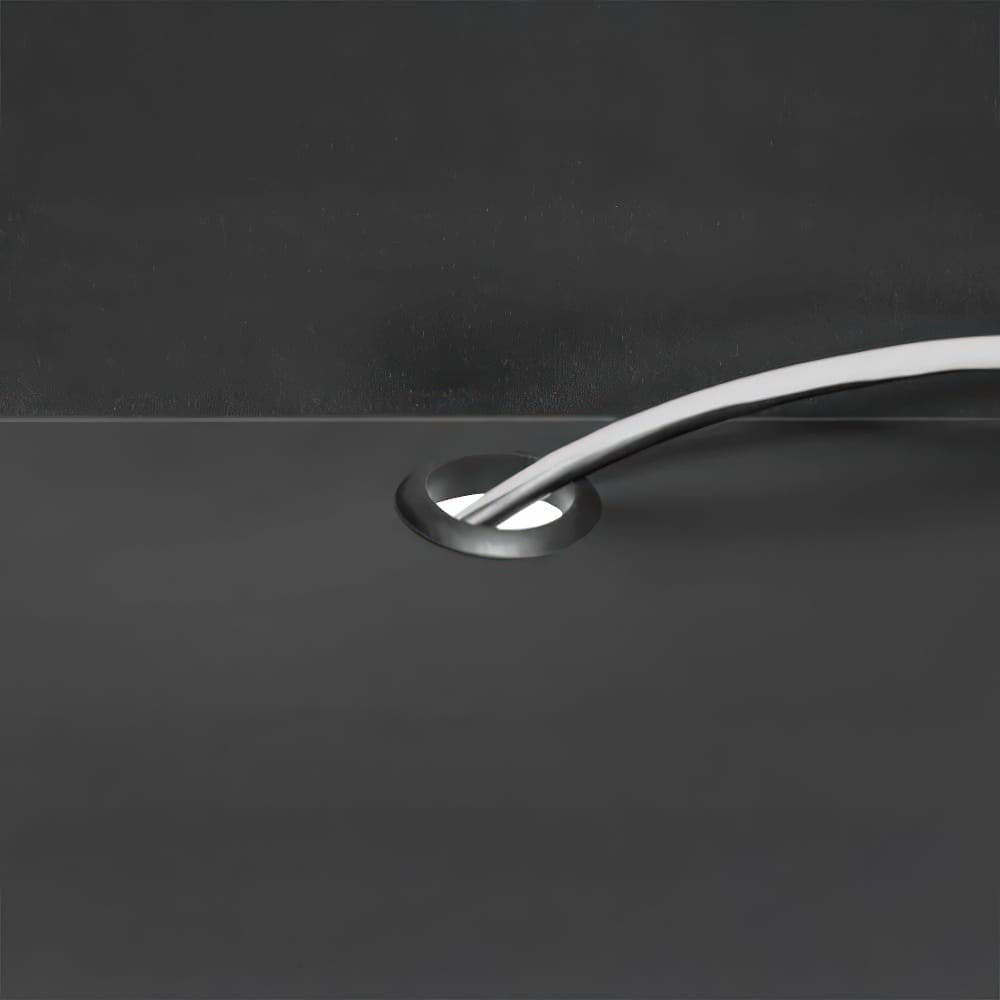 Close-Up View Shows Two White Cables Neatly Routed Through A Round Grommet In A Smooth Black Surface