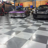 Checkered Racedeck Tiles Housing A Classic Purple Muscle Car And A Modern Black Cadillac