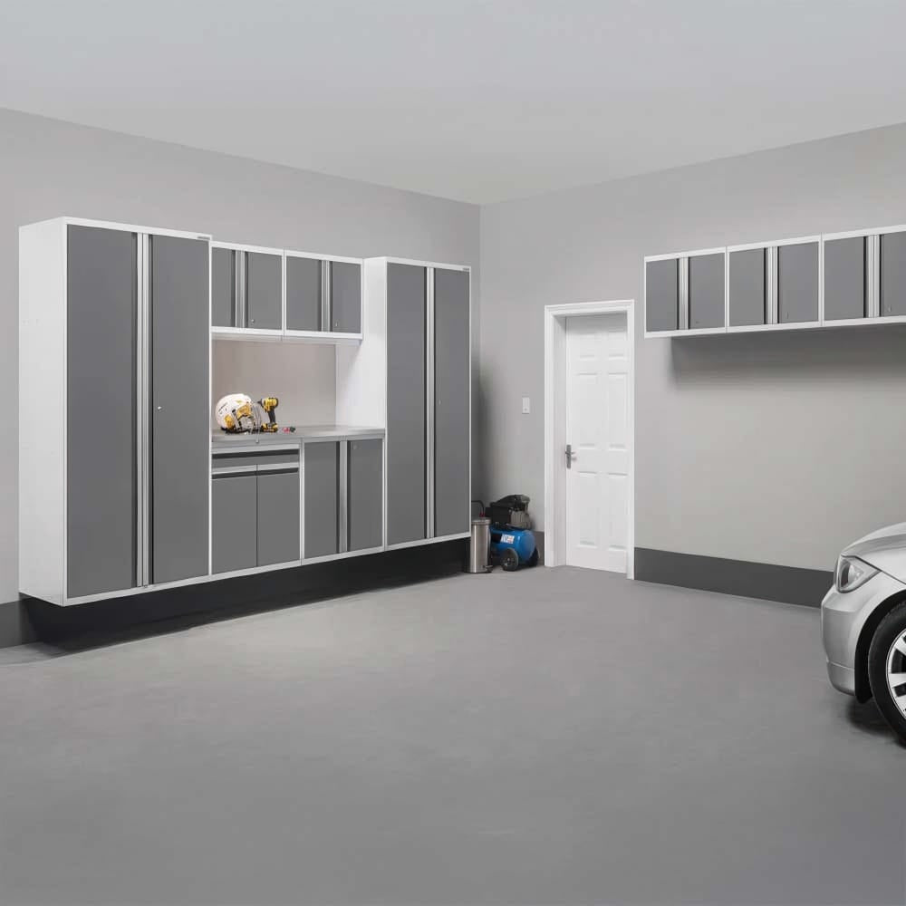 Clean Garage With Wall Mounted Gray Cabinets White Trim Work Nook And Parked Car Near White Door