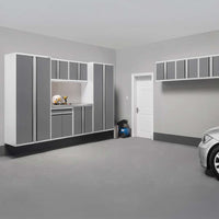 Clean Garage With Wall Mounted Gray Cabinets White Trim Work Nook And Parked Car Near White Door
