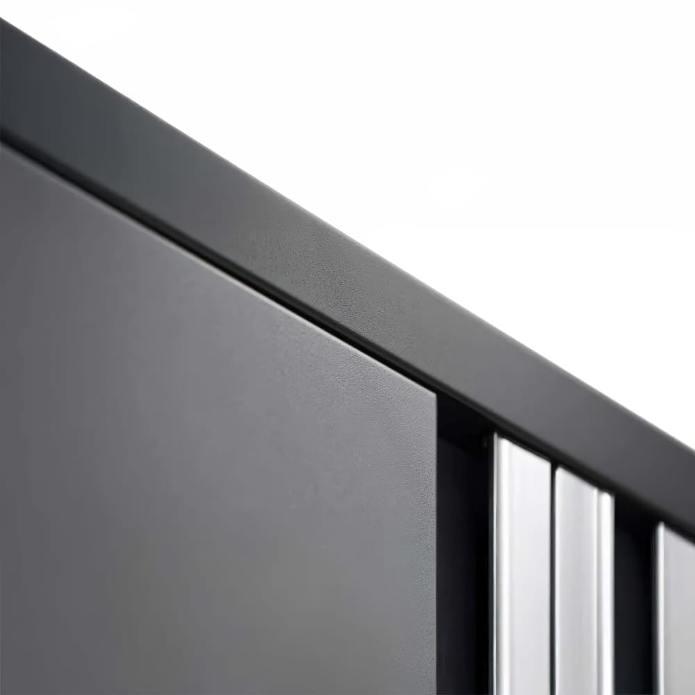 Close-Up Angled View Captures The Top Edge Of A Matte Black Cabinet With Sleek Integrated Silver Handles