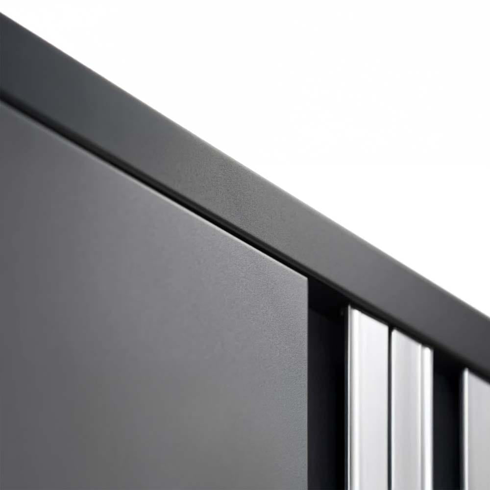 Close-Up Angled View Of The Top Edge Of A Sleek Matte Black Cabinet With Integrated Silver Vertical Handles And Smooth Finish