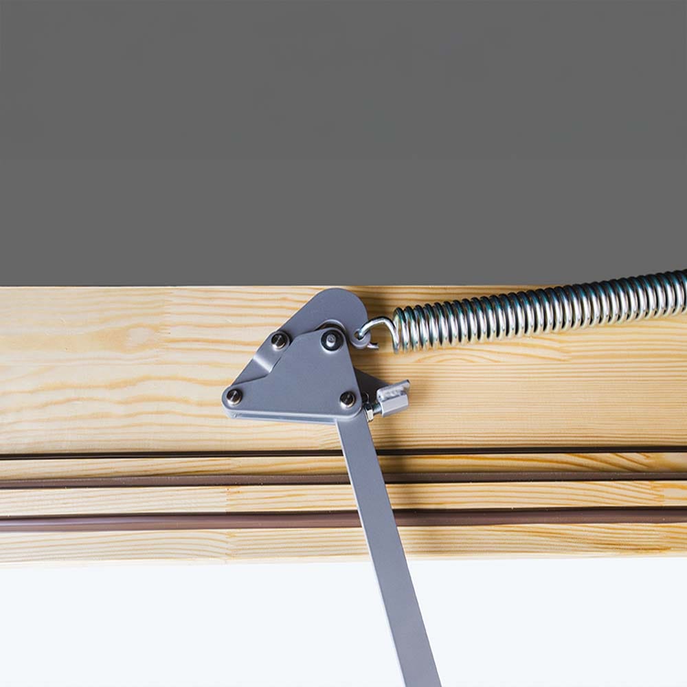 Close-Up Of A Metal Spring-Loaded Hinge Mechanism Attached To A Wooden Frame