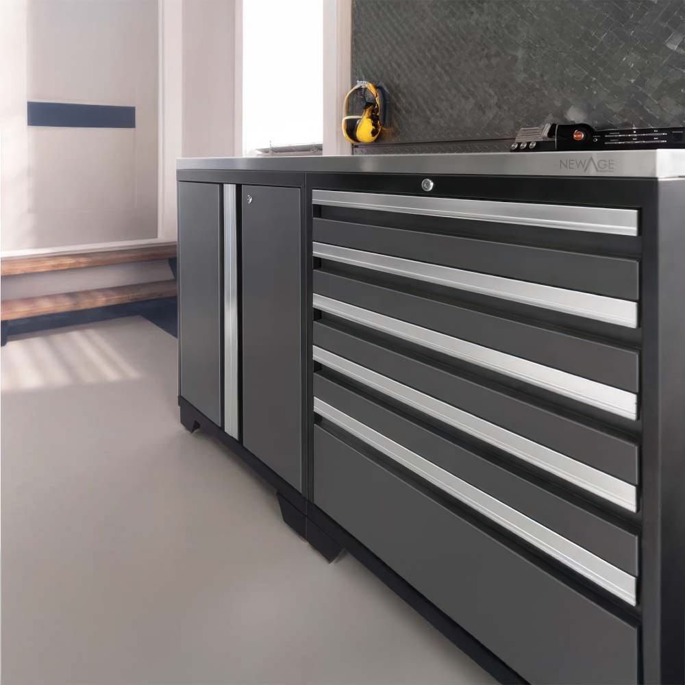 Close-Up Of A Modern Garage Tool Cabinet With Sleek Drawers And Ear Protection Hanging On The Wall