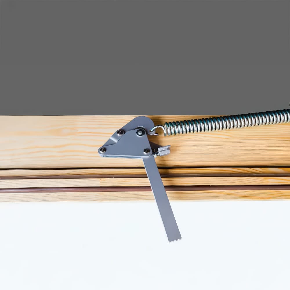 Close-Up Of A Spring-Loaded Metal Hinge Mechanism Attached To A Wooden Attic Ladder Frame