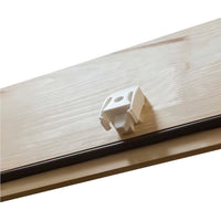Close-Up Of A White Plastic Latch Or Locking Mechanism Mounted On A Wooden Attic Hatch Door