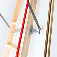 Close-Up Of A Wooden Attic Ladder Featuring A Red Handrail And Metal Support Arm Securely Fastened To The Hatch Door