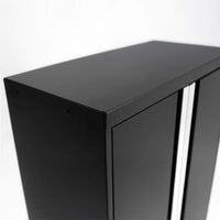 Close-Up Of Black Metal Garage Cabinet With Sleek Top Edge And Silver Handle Strips