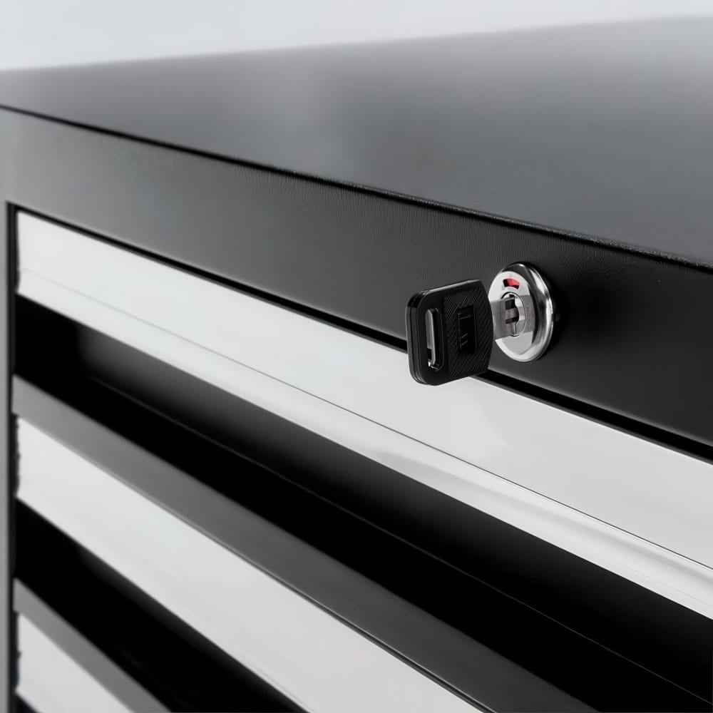 Close-Up Of Lockable Tool Cabinet With Key In Cylinder Above Metal Drawer Fronts