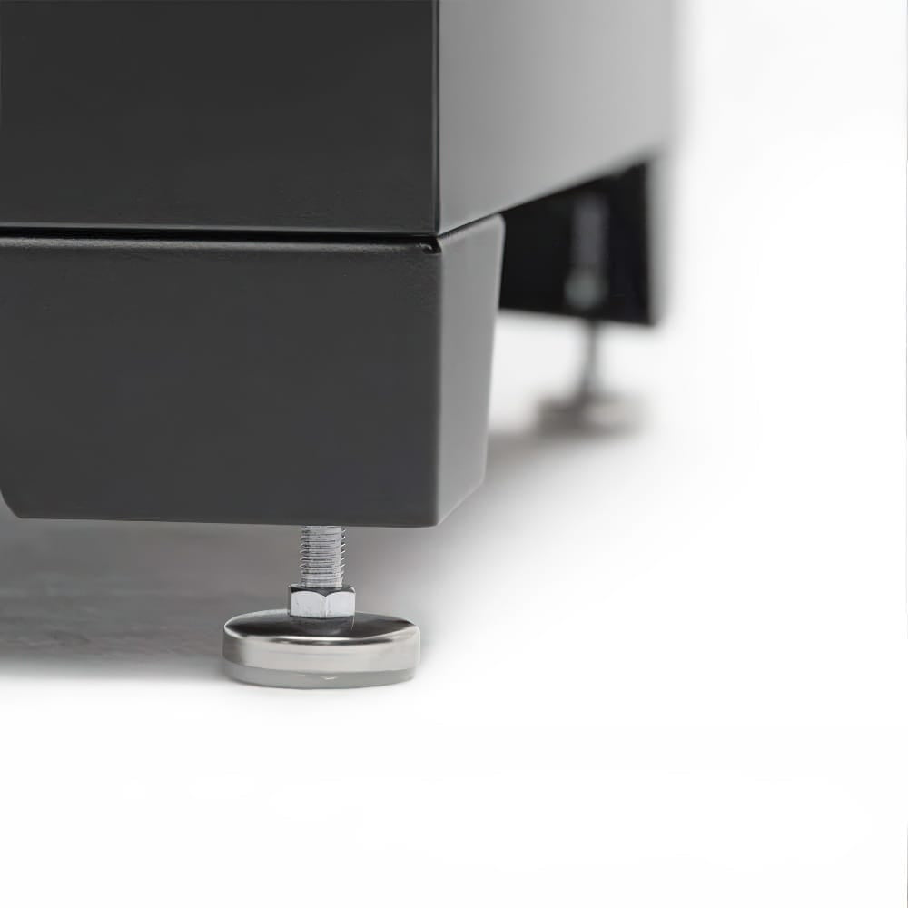Close-Up Of The Adjustable Leveling Feet Beneath A Black Metal Cabinet