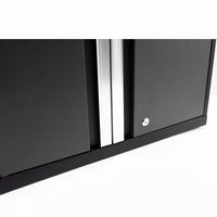 Close-Up Of The Bottom Section Of A Black Cabinet With Two Doors Featuring Vertical Silver Handles And A Lock Mechanism On The Right