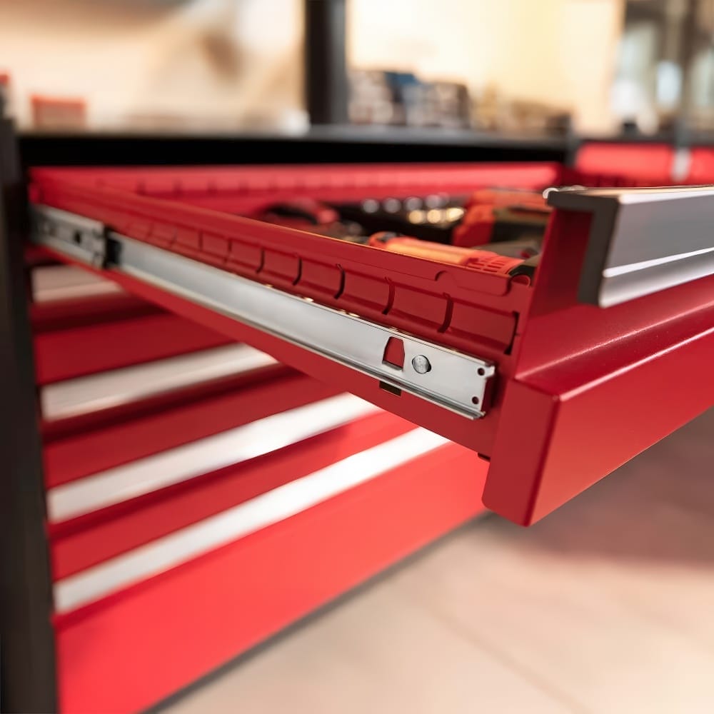 Close-Up View Of An Open Red Tool Drawer With Metal Sliding Mechanism