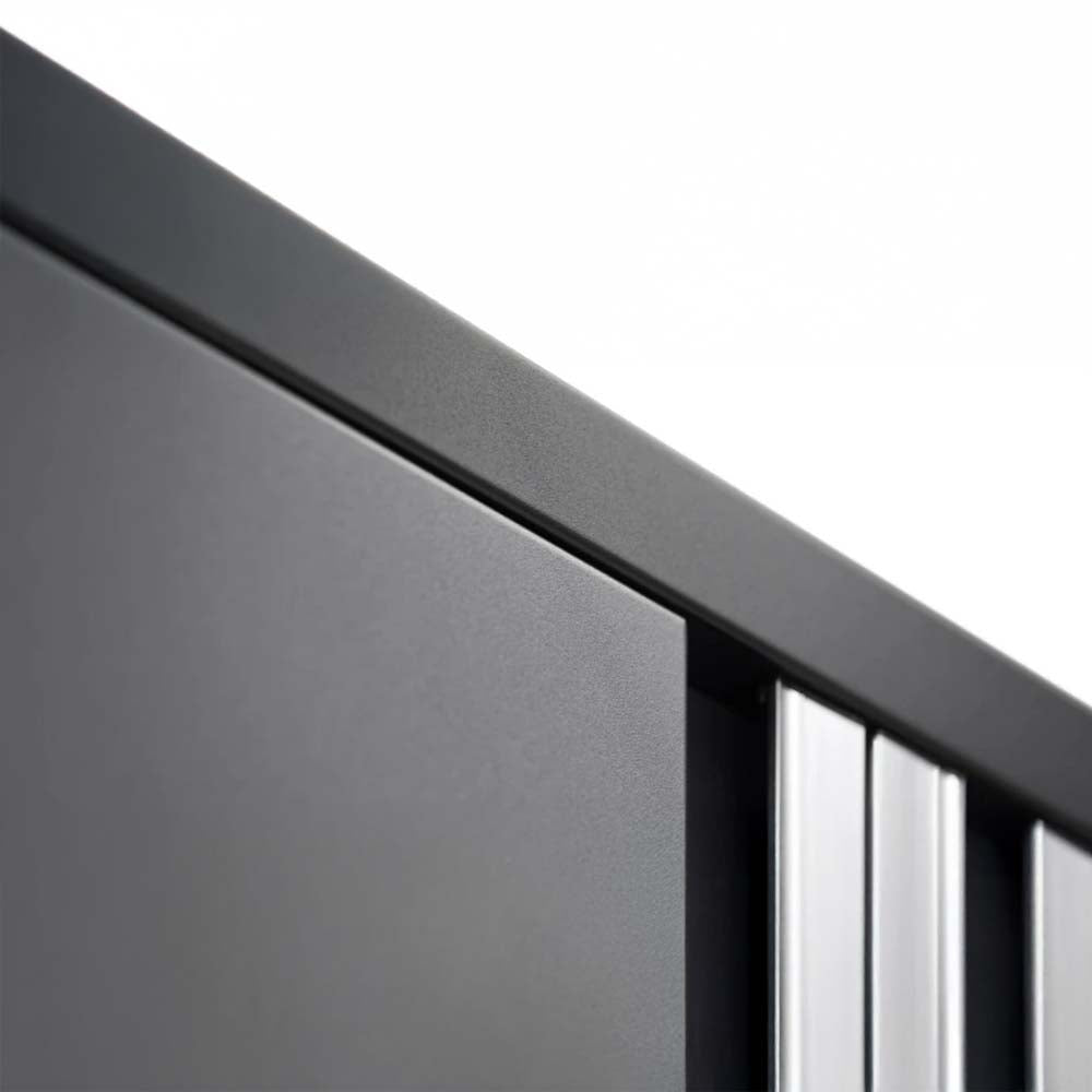 Close-Up View Of The Top Corner Of A Black Storage Cabinet Highlighting Its Smooth Matte Finish And Vertical Silver-Accented Handle Design