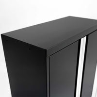 Close-Up View Of The Top Corner Of A Sleek Black Metal Storage Cabinet With Vertical Silver Handles