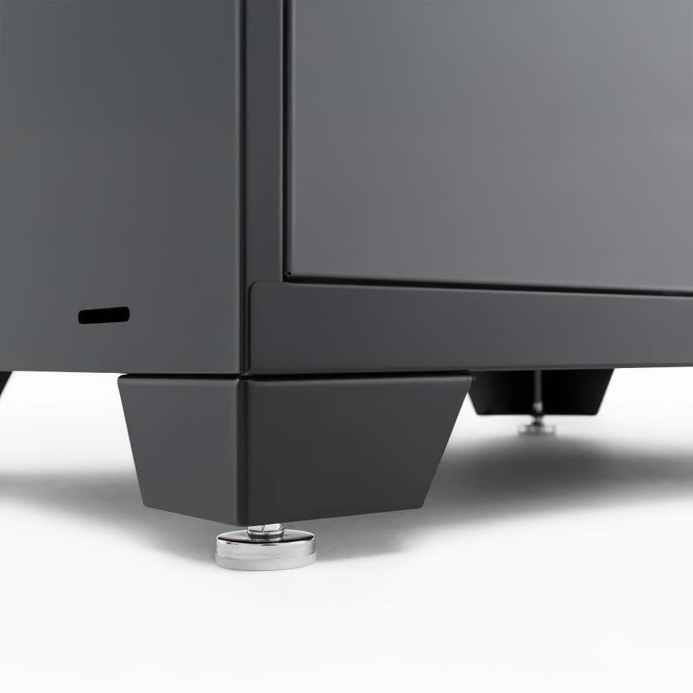 Close Up Of A Cabinet Leg With Adjustable Leveling Feet On A Smooth White Surface