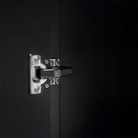 Close Up Of A Chrome Cabinet Hinge Mounted On A Dark Matte Door Surface