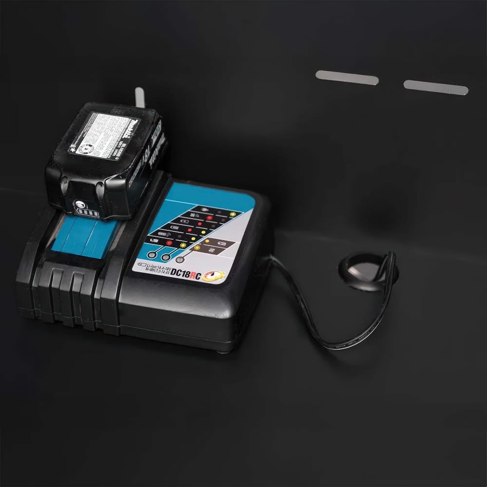 Cordless Tool Battery Charging On Black Shelf With Built In Cable Grommet And Vent Slots