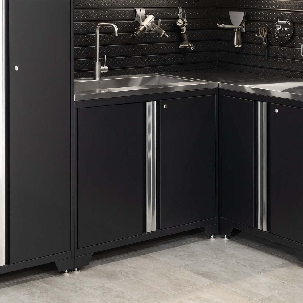 Corner Garage Workstation With Dual Stainless Sinks And Black Cabinets Featuring Mounted Tools On Diamond Plate Backwall