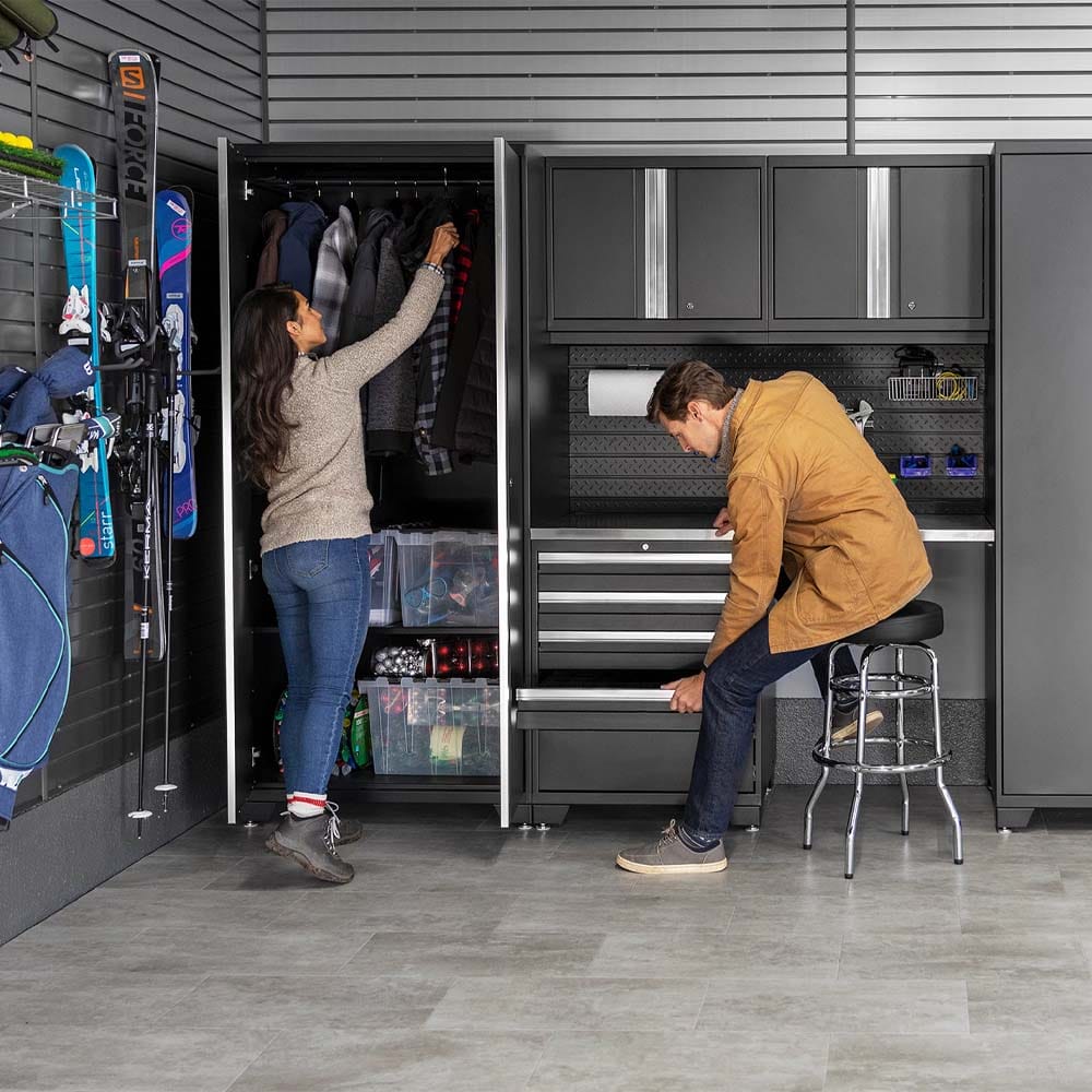 Couple Organizing A Sleek Garage With Ski Gear Coat Storage And Tool Drawers