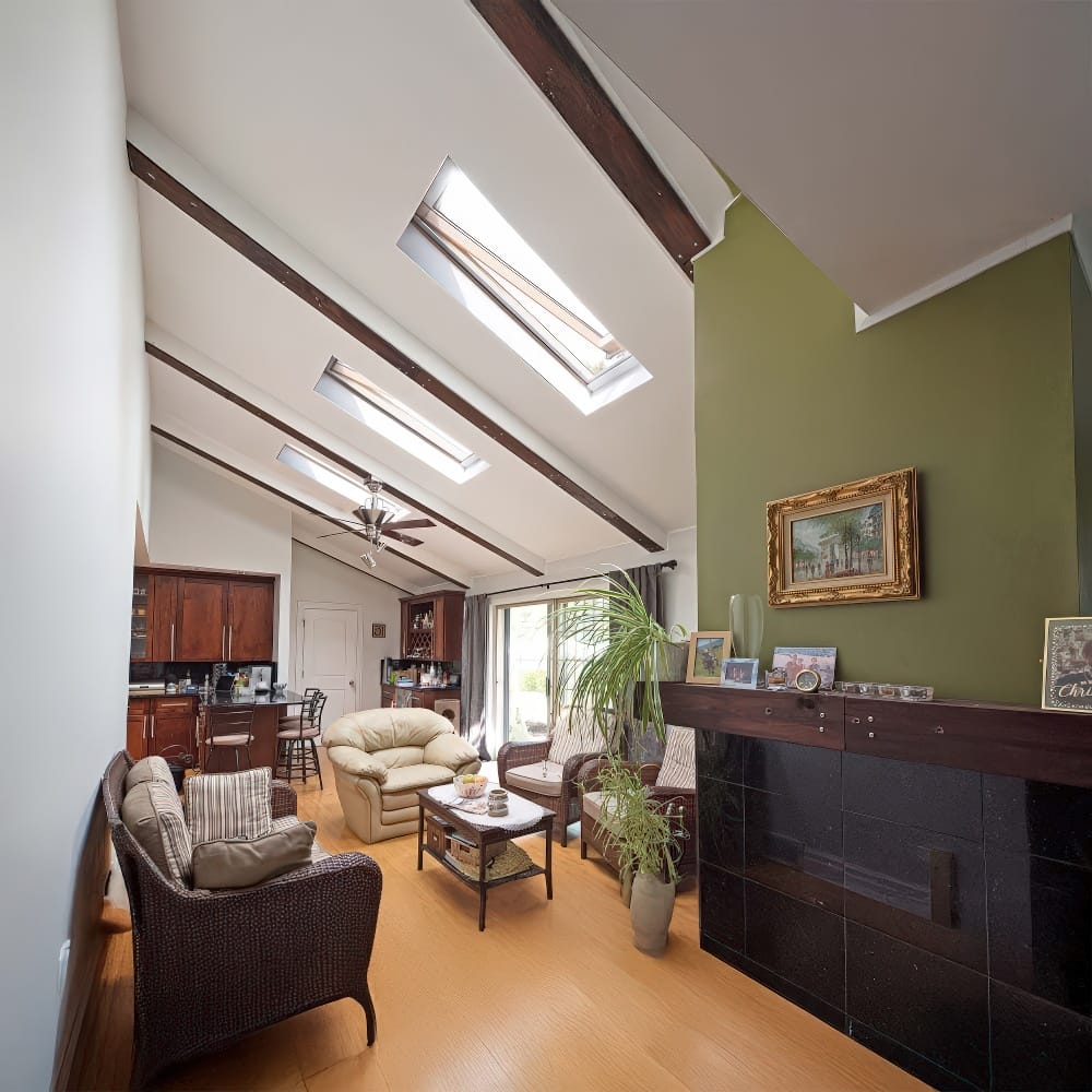 Cozy Living Room With Exposed Beams And Multiple Skylights Filling The Space With Natural Light