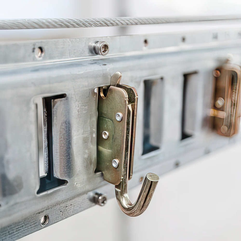 Detailed View Of A Metal Hook Mounted On A Galvanized Bracket Part Of An Organized Storage System