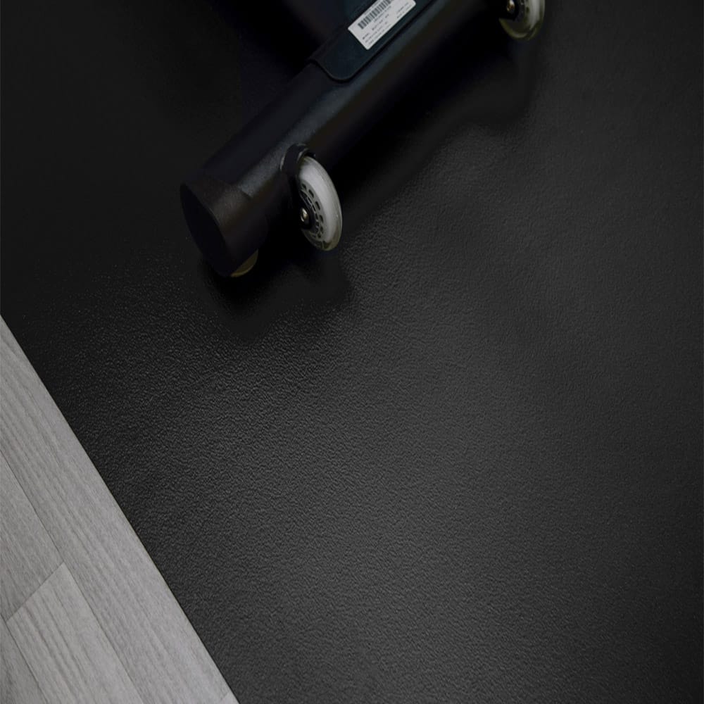 G-Floor Vinyl Flooring Adjacent To A Light Gray Wooden Floor With A Portion Of A Wheeled Object
